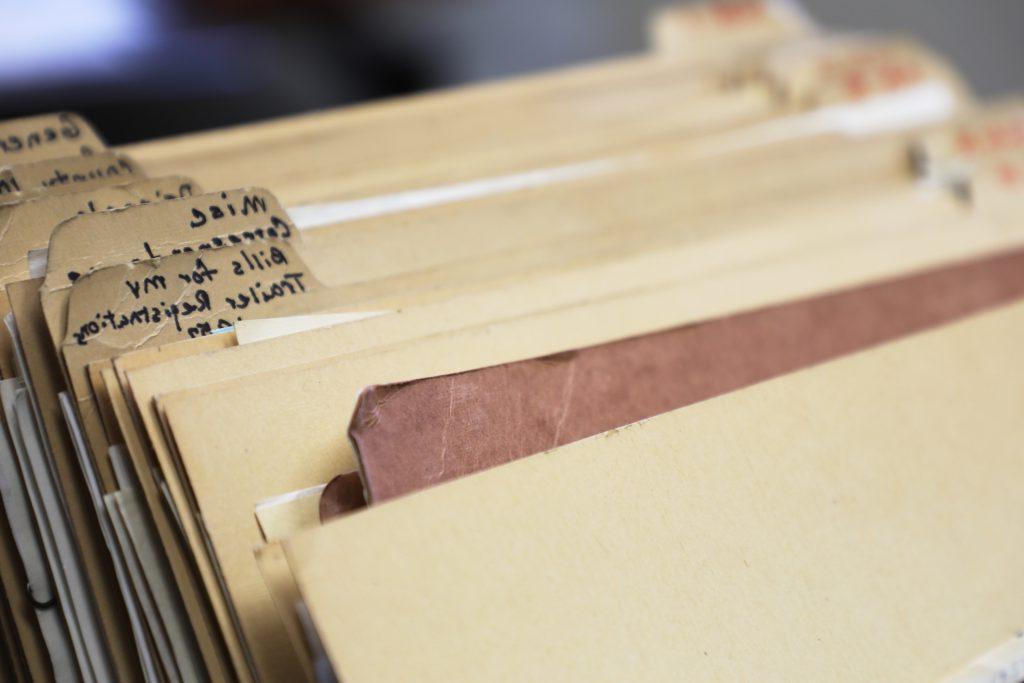 A stack of folders filled with correspondence letters from 1923 to 1976 at the Garfield County Clerk and Recorder's Office in Glenwood Springs, CO.
