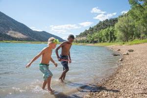Two boys run to shore at Harvey Gap State Park north of Sil